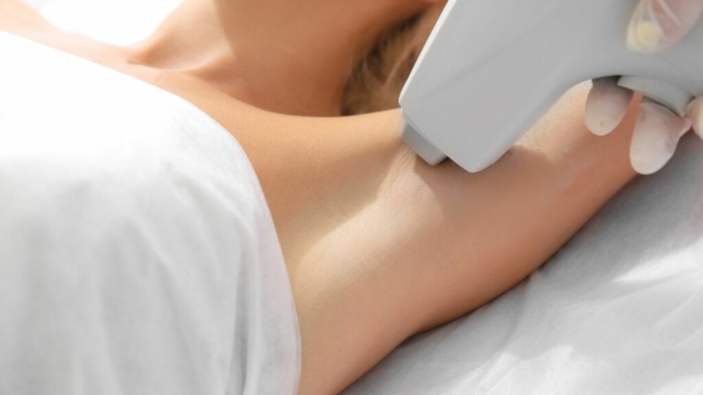 Woman getting a laser hair removal on her underarm.