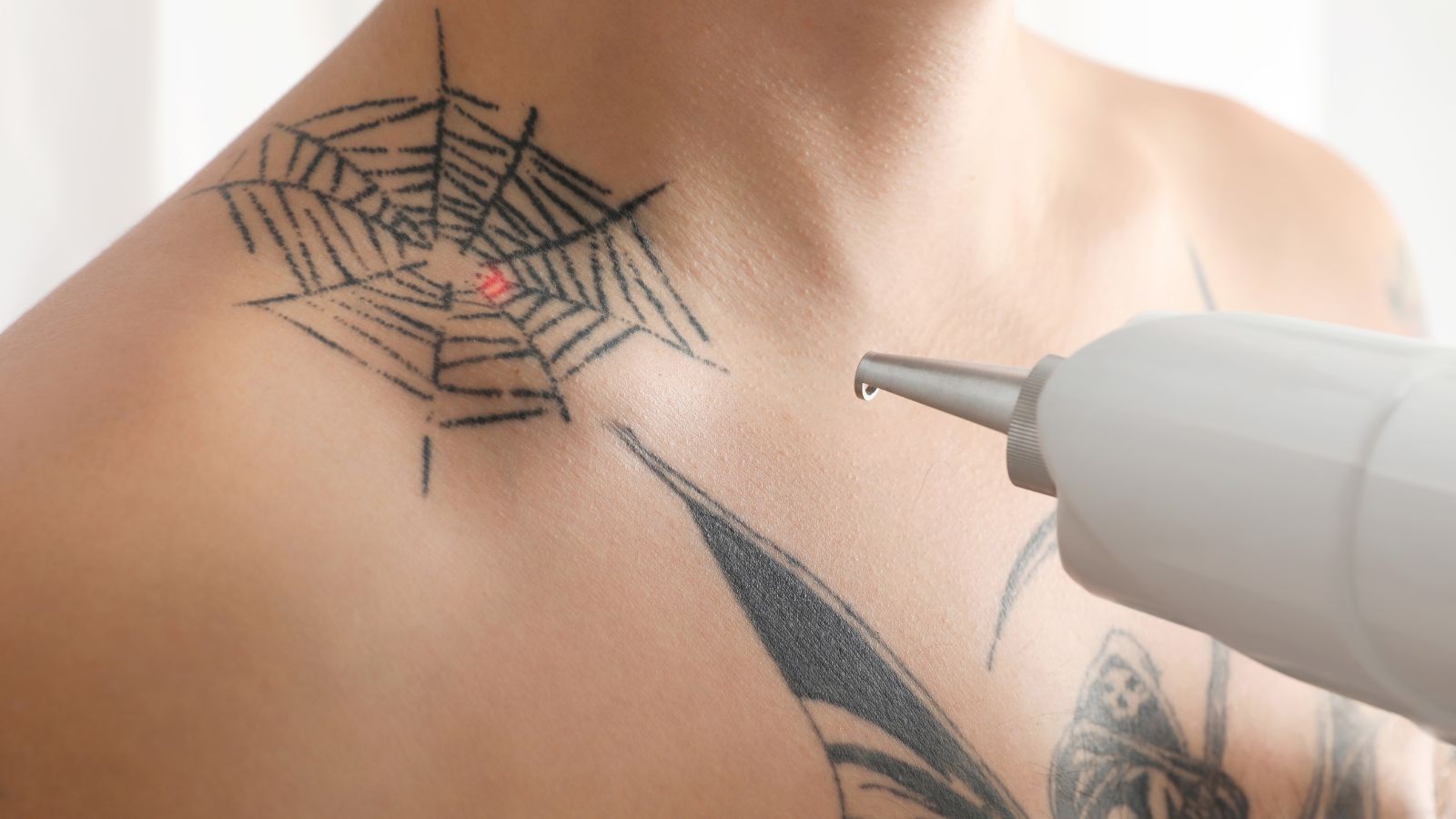 A Spider web tattoo in the shoulder.